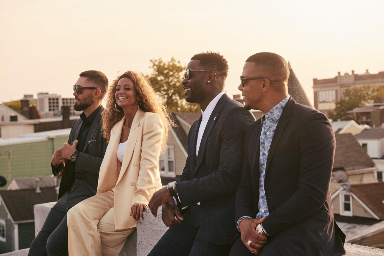 A group of people sitting on a benchDescription automatically generated