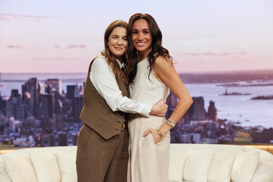 A couple of women posing for a pictureAI-generated content may be incorrect.
