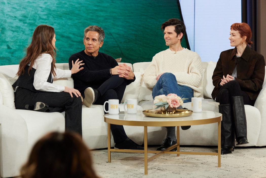 A group of people sitting on a couchDescription automatically generated