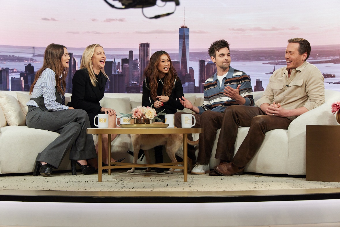 A group of people sitting on a couchAI-generated content may be incorrect.