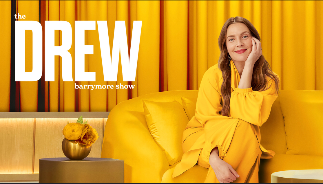 A person in a yellow dress sitting on a couchAI-generated content may be incorrect.