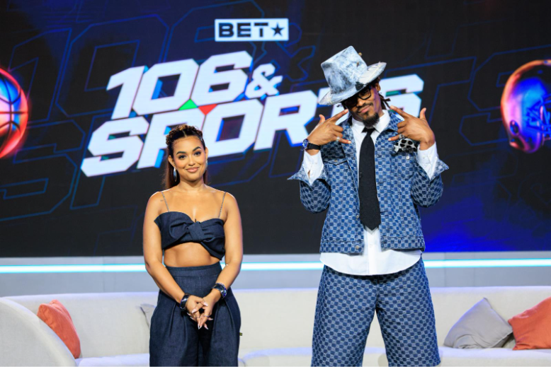 A person and person on a stageAI-generated content may be incorrect.