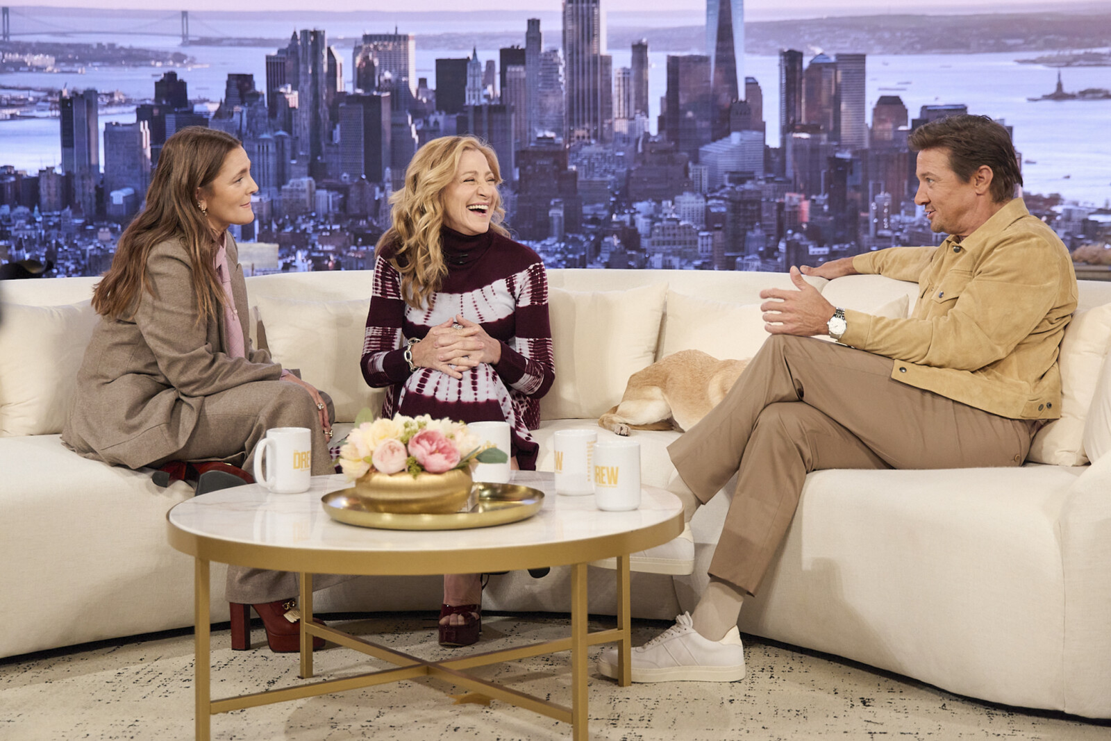 A group of people sitting on a couchAI-generated content may be incorrect.