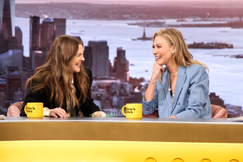 Two women sitting at a tableAI-generated content may be incorrect.