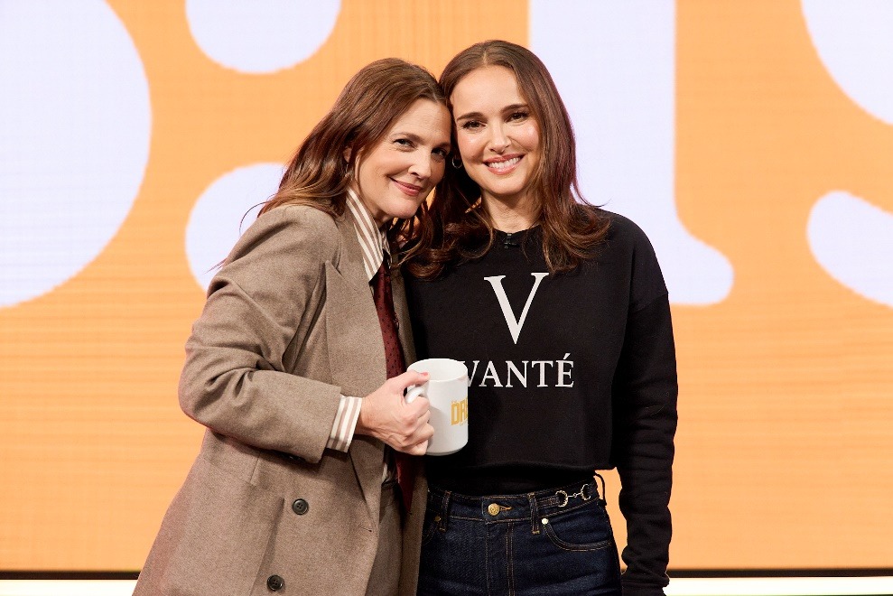 Two women standing together holding a mugAI-generated content may be incorrect.