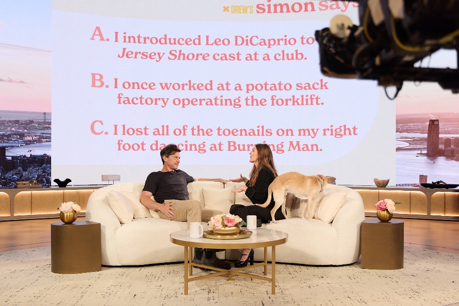 A person and person sitting on couches with a dogAI-generated content may be incorrect.