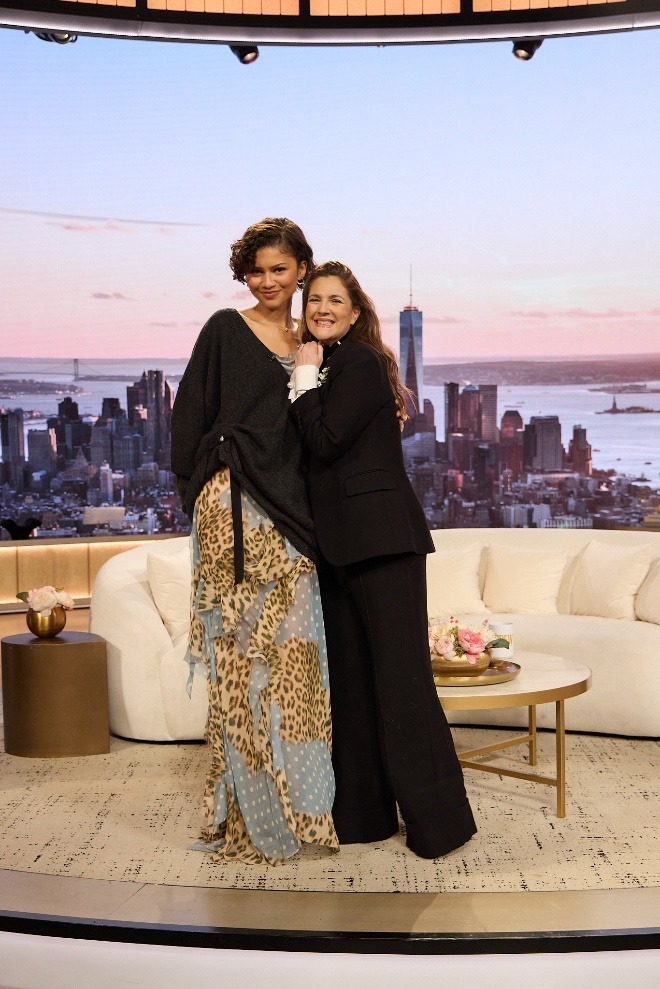 Two women posing for a pictureAI-generated content may be incorrect.