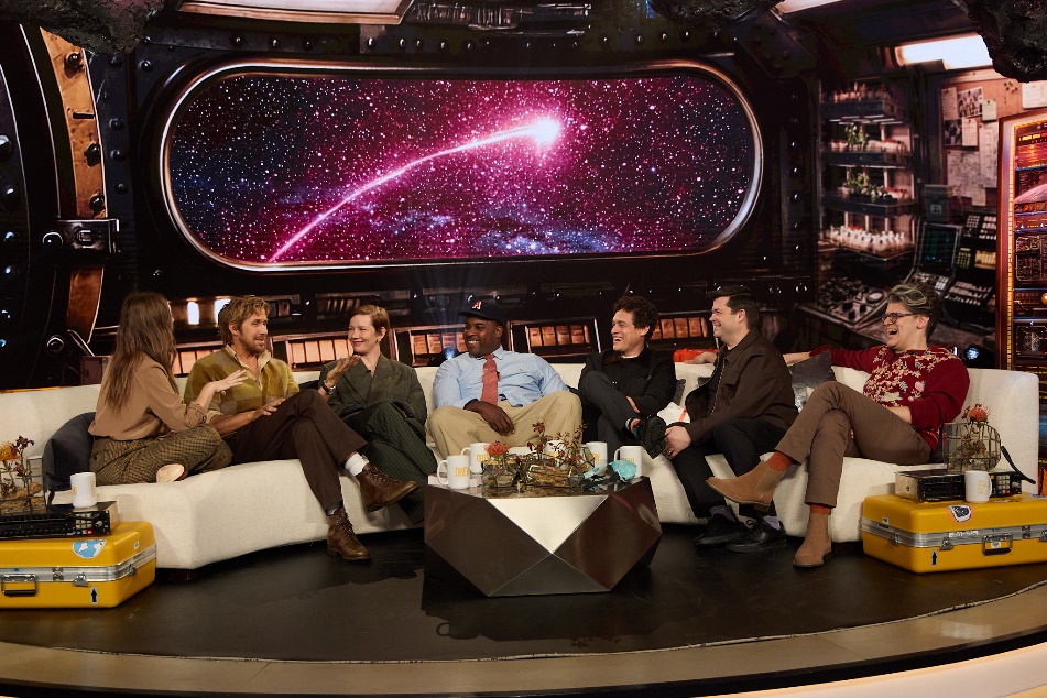 A group of people sitting on a couchAI-generated content may be incorrect.