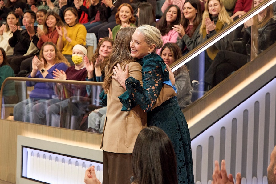 A group of women huggingAI-generated content may be incorrect.