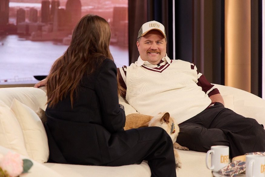 A person sitting on a couch with a dogAI-generated content may be incorrect.