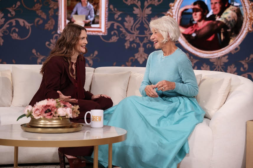 A person sitting on a couch talking to another personDescription automatically generated