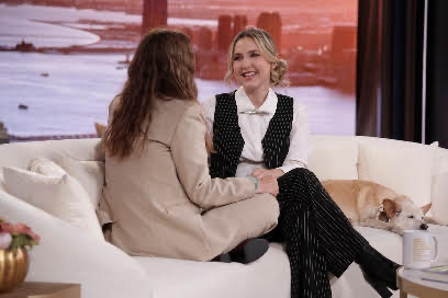 Two women sitting on a couchDescription automatically generated