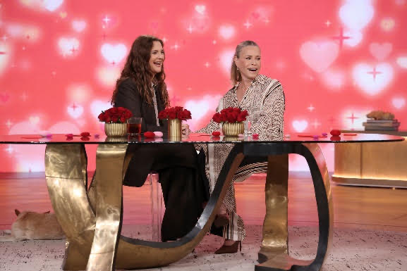 Two women sitting at a tableDescription automatically generated